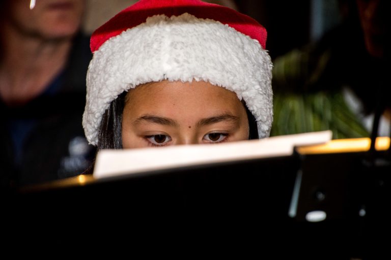 girl playing piano santa hat